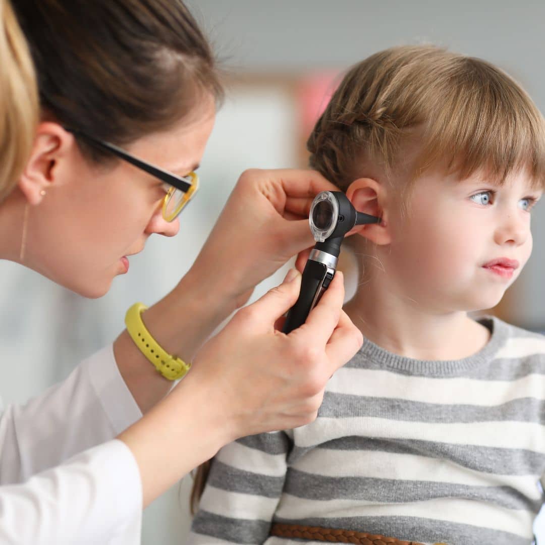 doctor looking in child's ear