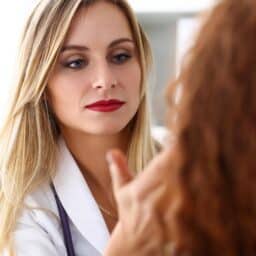 Doctor looking at woman's face
