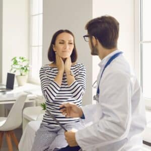 Woman talking to doctor.