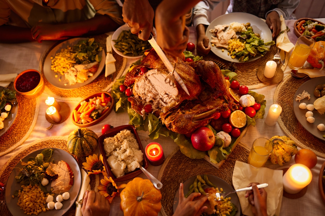 Above view of man cutting roasted turkey on Thanksgiving.