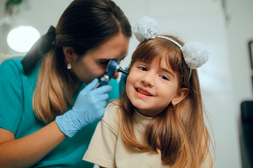 Young girl getting an ear exam